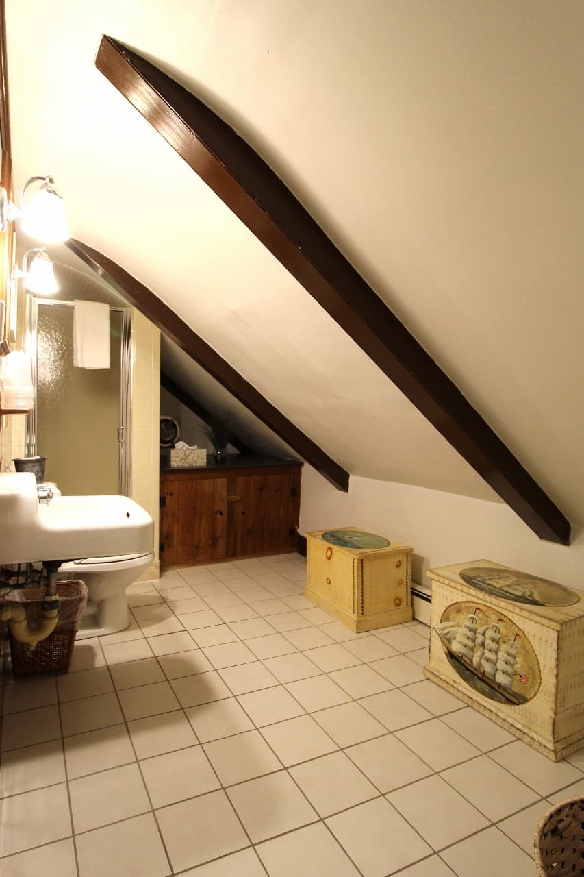 Bathroom with slanted ceiling for rooms 6 and 7