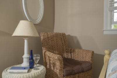 A wicker chair with a glass of wine