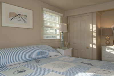 A blue bedspread on the large king bed in room 16