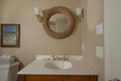 Bathroom sink and round sailors knot mirror