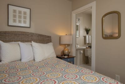 The en-suite bathroom is next to the bed in this petite queen room #12