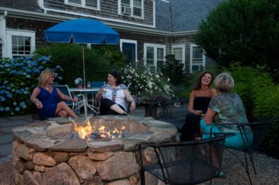 Guests enjoy the firepit at our Cape Cod hotel