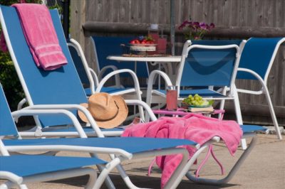 Pool loungers with towels and sunhat