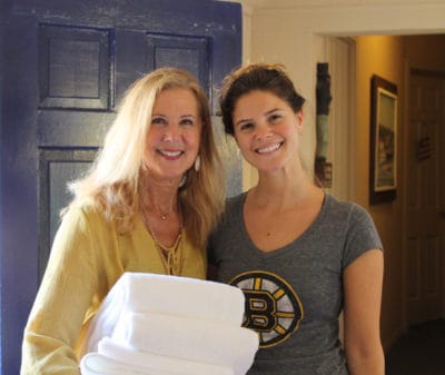 Denise and her daughter providing towels to guests