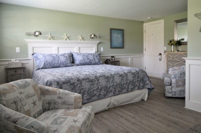 The deluxe king room bed with tasteful linens and decor