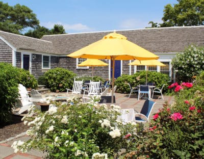 Colorful patio area with flowers and yellow umbrellas